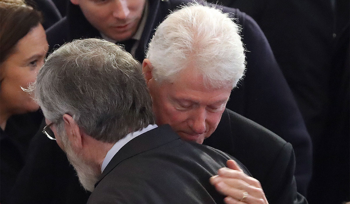 Former US President Bill Clinton hugs Sinn Fein president Gerry